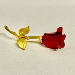 Vintage red rose brooch Avon with a gold-tone stem and leaves.